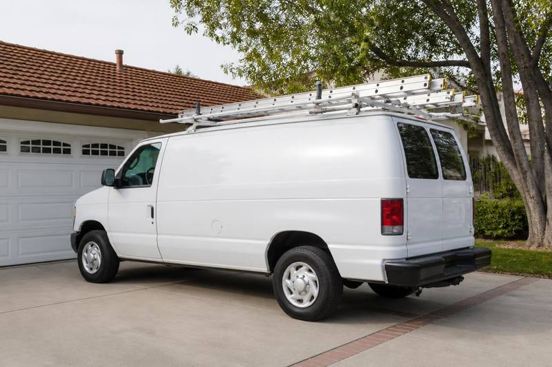 Service van parked in a residential driveway in front of a garage